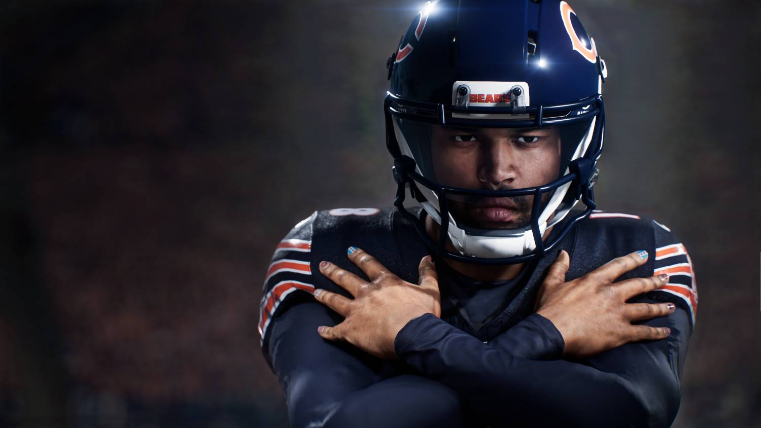 Un jugador de fútbol americano con uniforme y casco de los Bears de Chicago, cruzando los brazos.