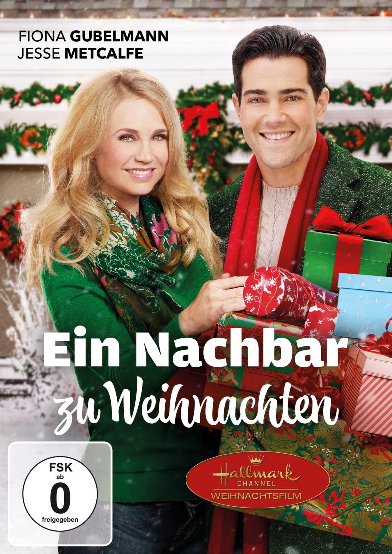Ein Mann und eine Frau lächeln vor Weihnachtsgeschenken. FSK ab 0.