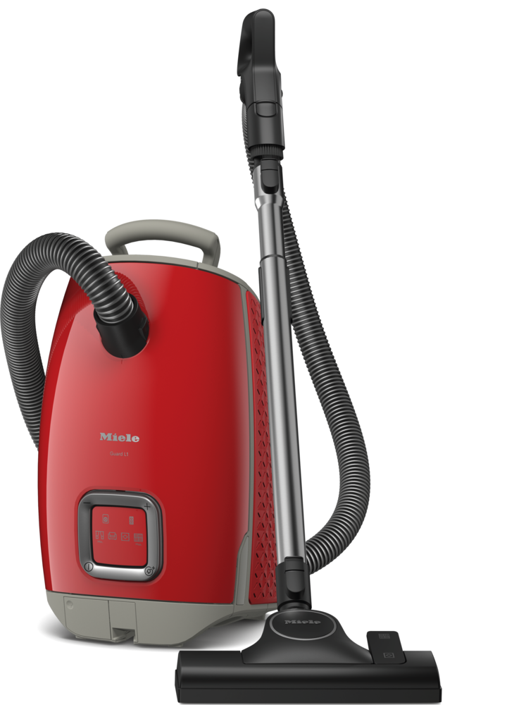 Ein roter Miele Staubsauger mit Schlauch und Bürste, isoliert auf schwarzem Hintergrund.