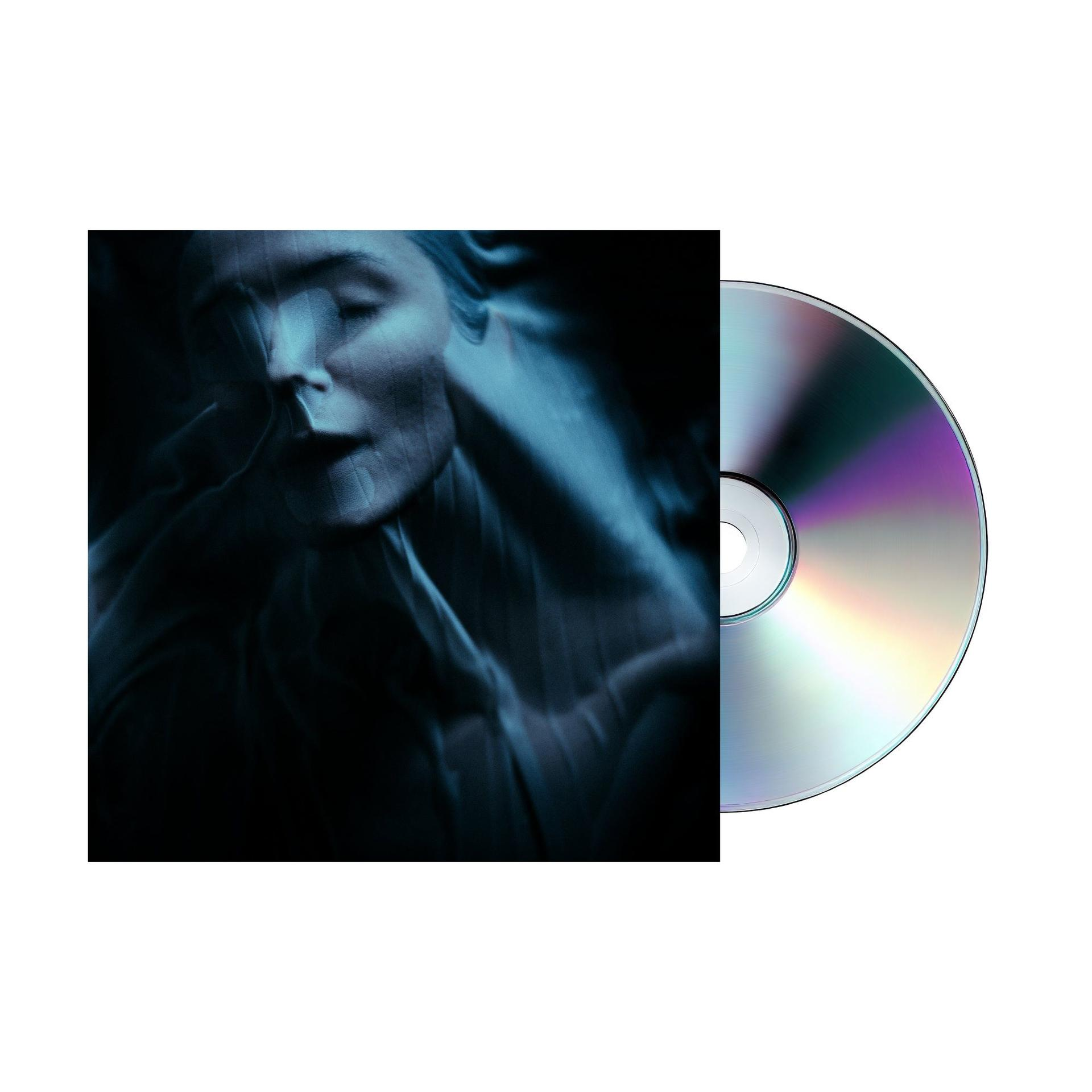 CD und Cover mit einer Frau, die von Stoff bedeckt ist, vor dunklem Hintergrund.