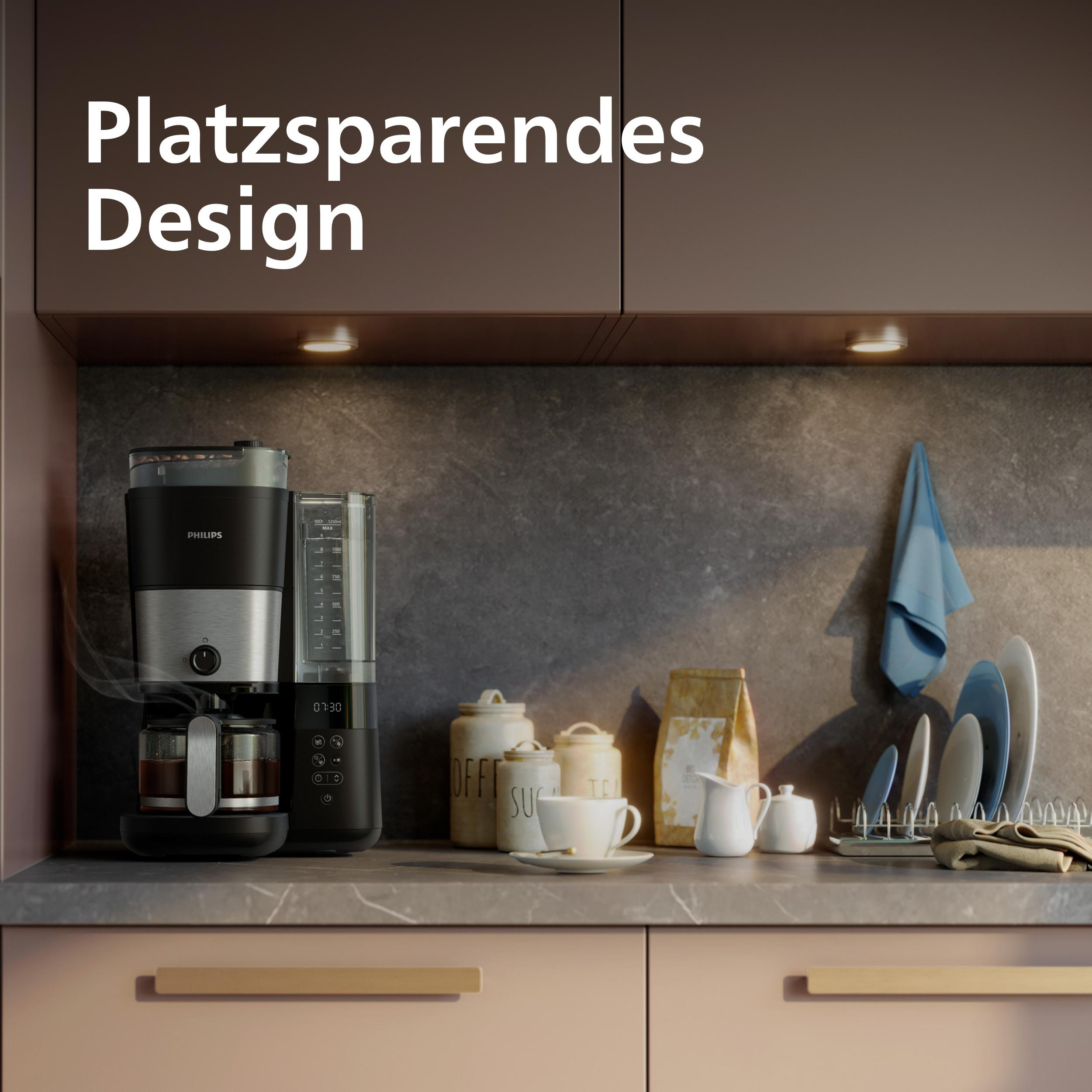 Eine Philips Kaffeemaschine mit Glaskanne auf einer Arbeitsplatte.