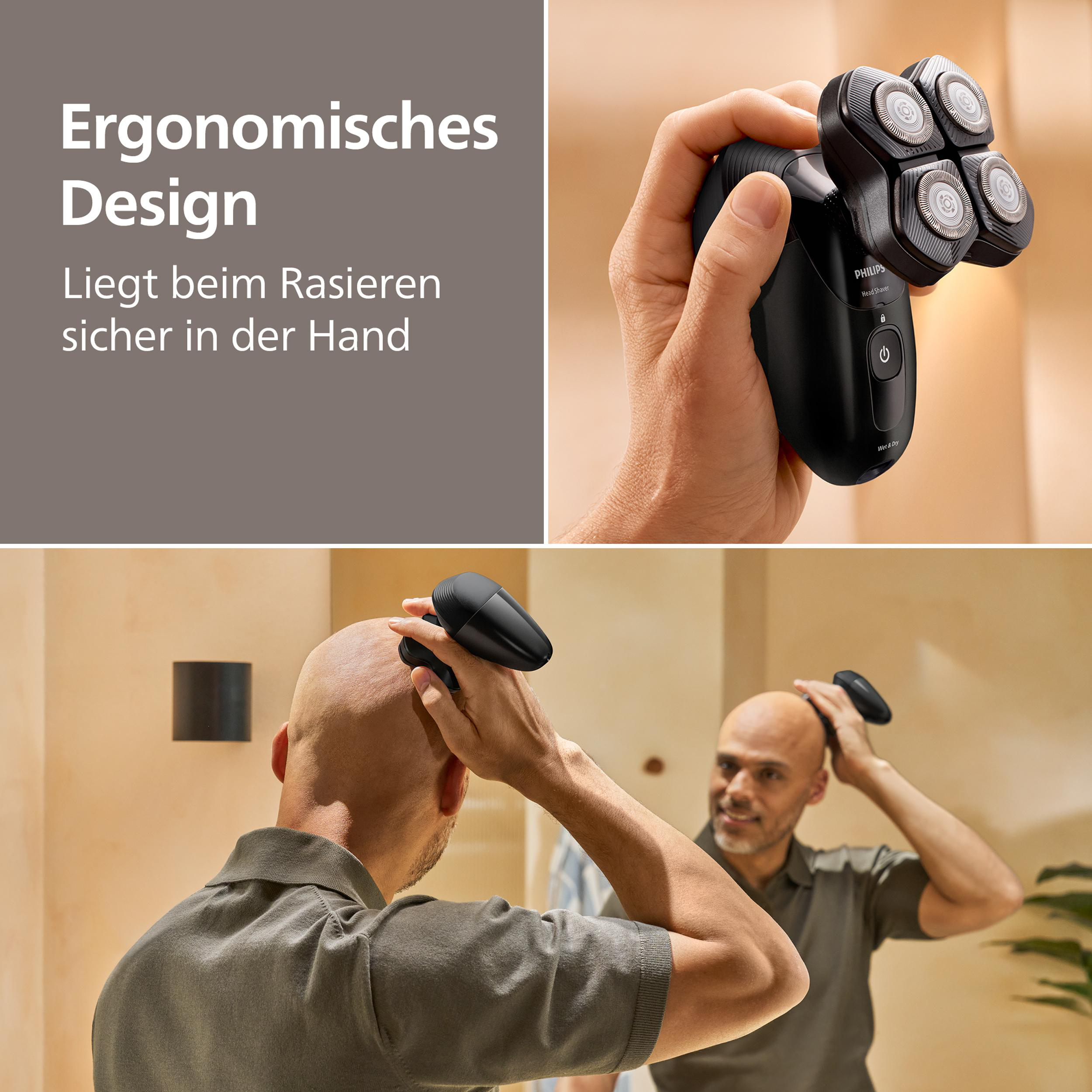 Mann rasiert seinen Kopf mit einem schwarzen Philips Rasierer.