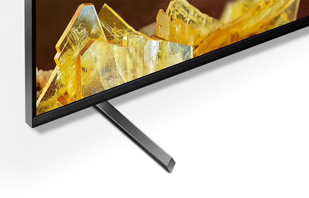 Sony TV sárga kristályokkal a képernyőn és fém állvánnyal.