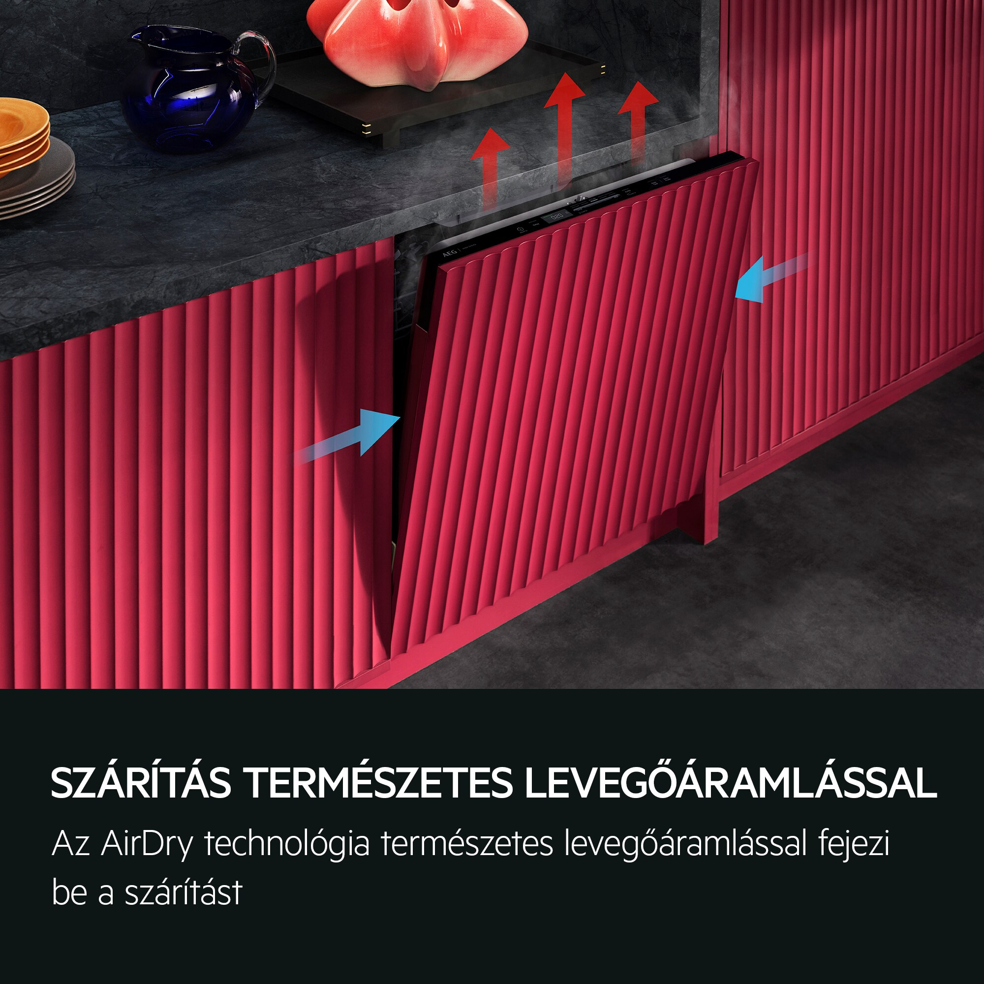 Beépített mosogatógép piros előlappal és légáramnyilakkal.
