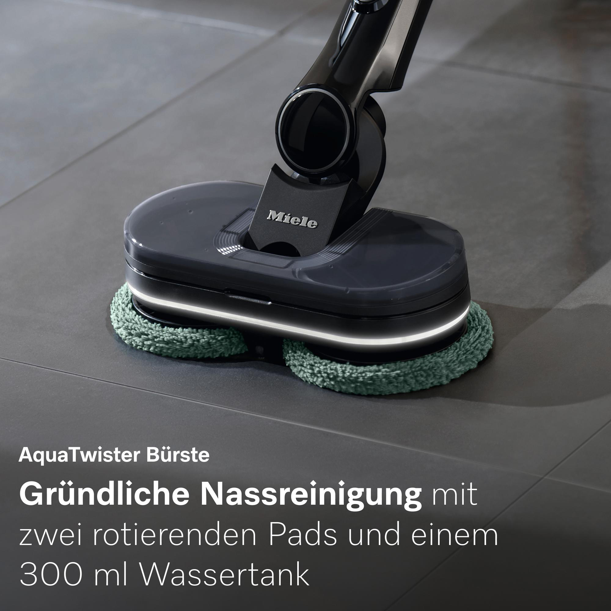 Miele AquaTwister Bürste mit zwei rotierenden Pads auf grauem Boden.