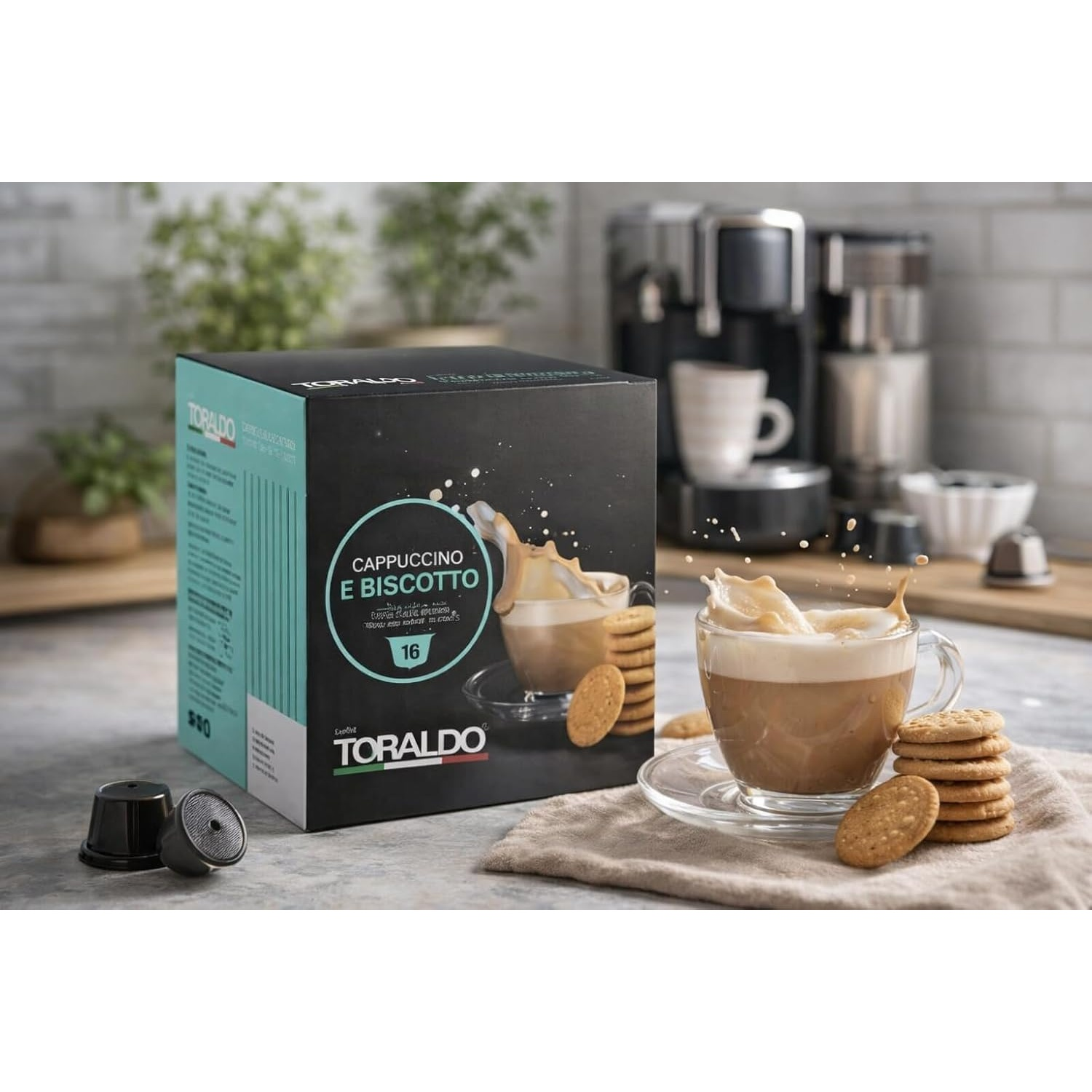 Scatola Toraldo Cappuccino E Biscotto con cialde di caffè, un bicchiere di cappuccino e biscotti.