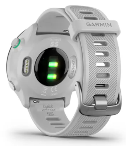 Biały smartwatch Garmin z zielonymi światłami i stykami ładowania.