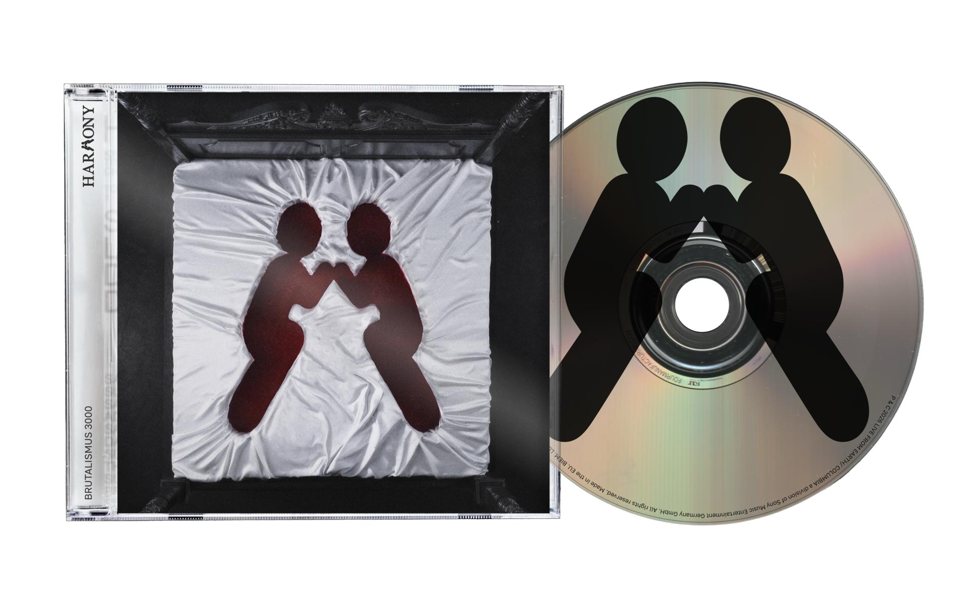 CD-Hülle und CD mit roten Silhouetten zweier Personen auf weißem Stoff und schwarzem Hintergrund.