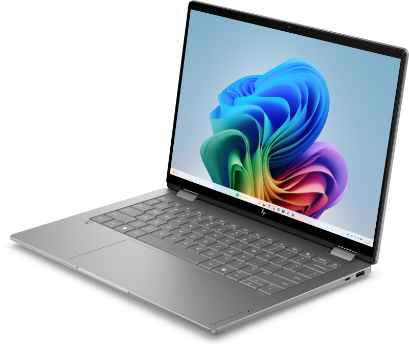Gümüş renkli HP OmniBook dizüstü bilgisayar açık, ekranında renkli soyut duvar kağıdı gösteriyor.