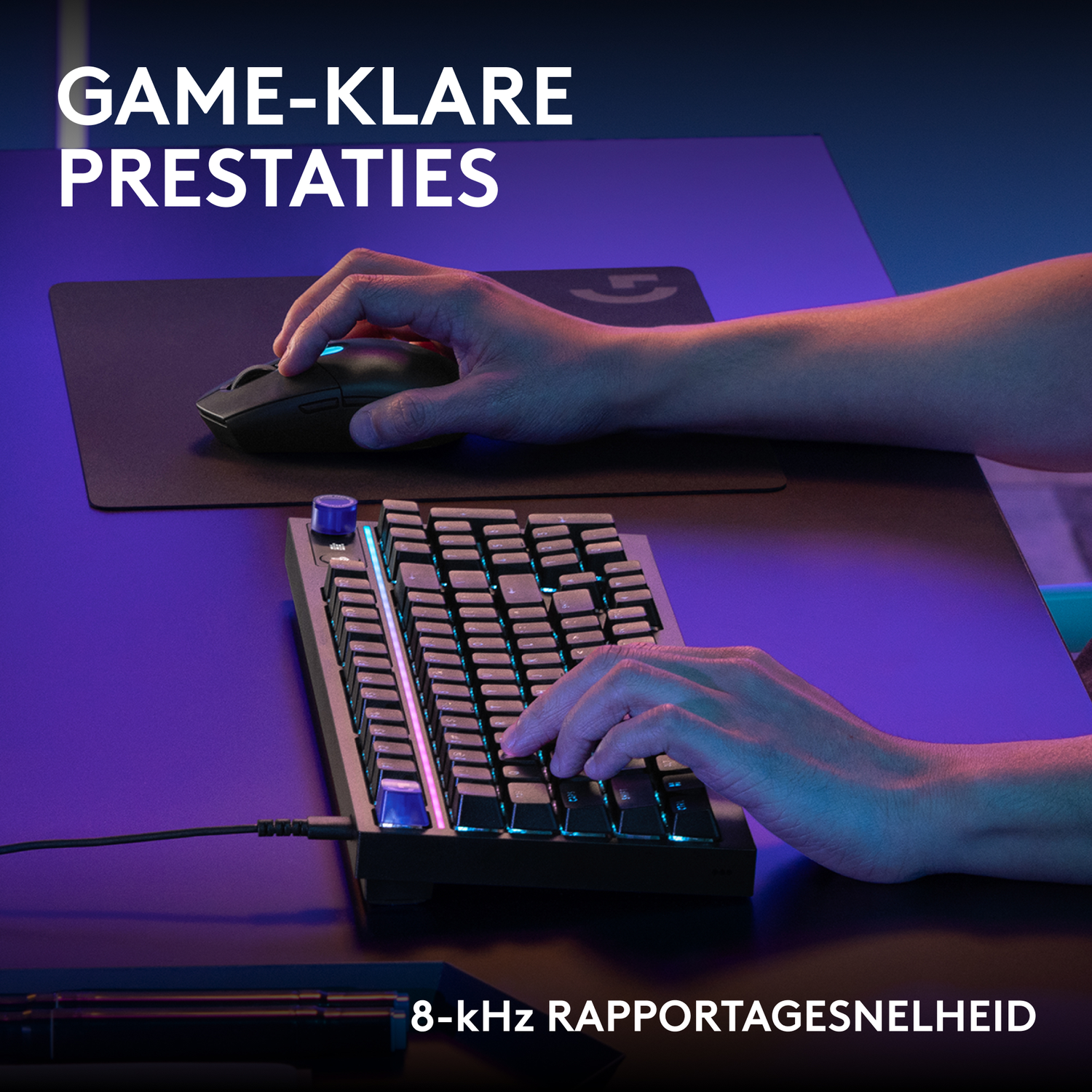 Hands typing on a backlit keyboard with a mouse on a pad.