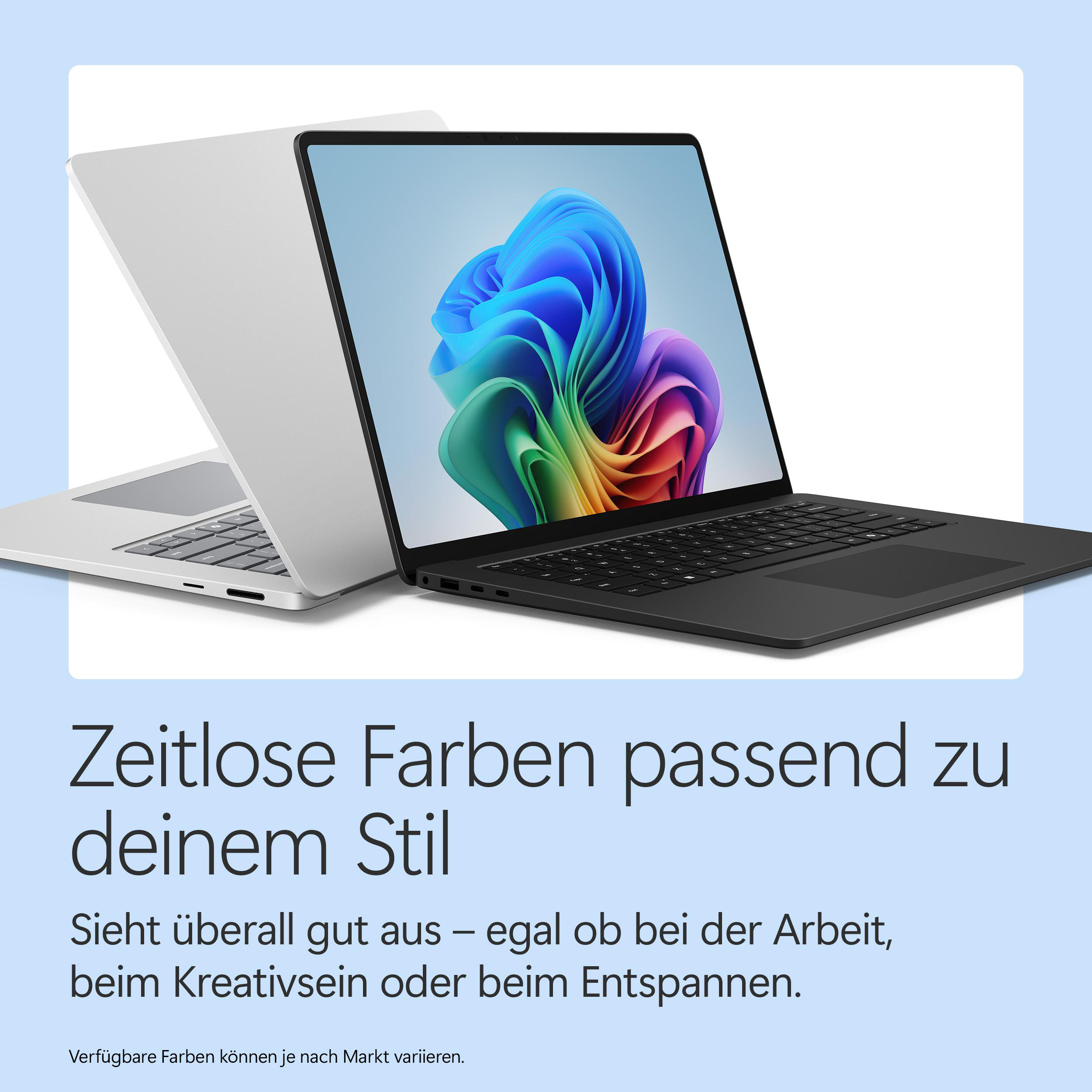 Zwei Laptops, einer schwarz, einer silber. Der schwarze Laptop zeigt ein buntes, abstraktes Bild.