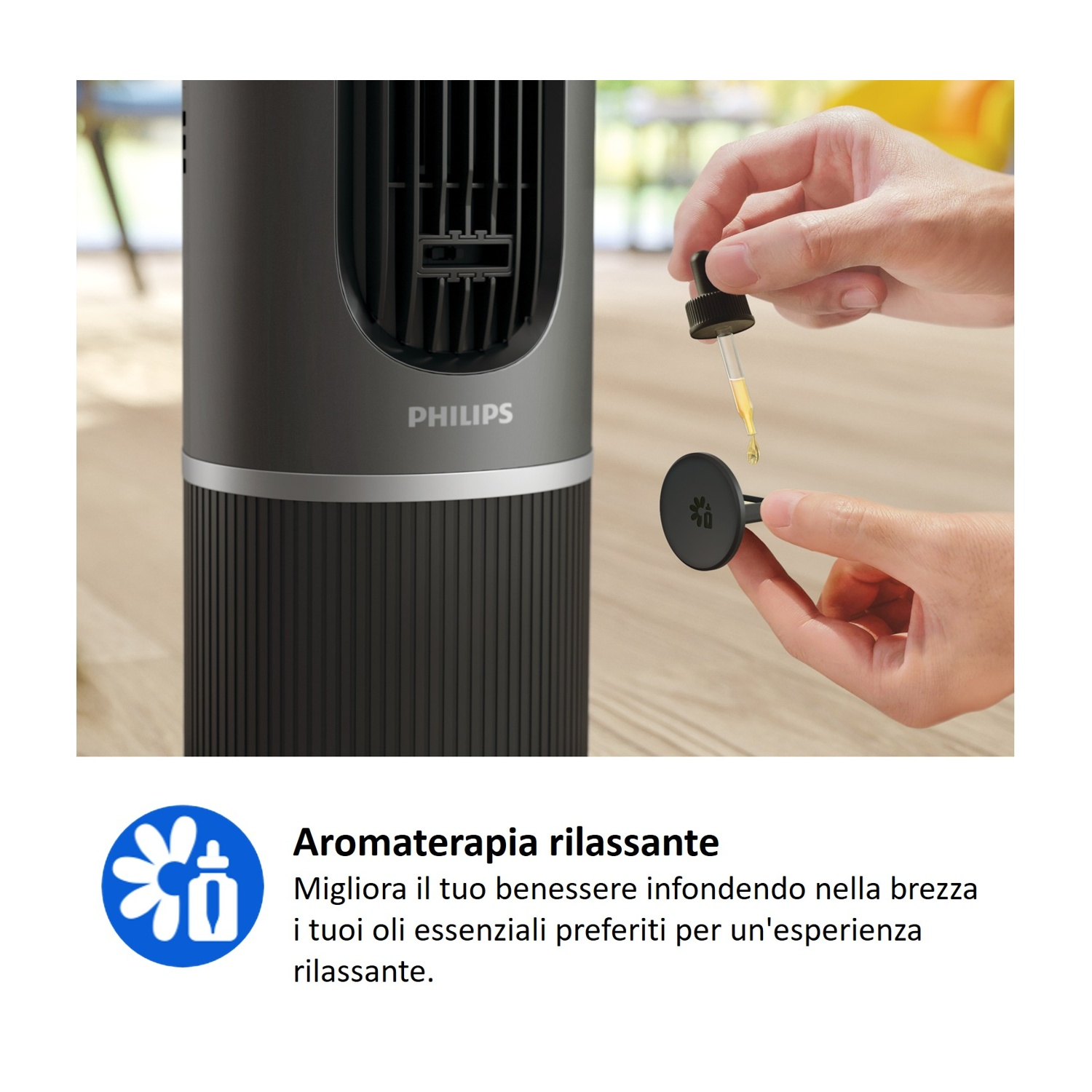 Una mano aggiunge olio da un contagocce a un diffusore vicino a un ventilatore Philips.