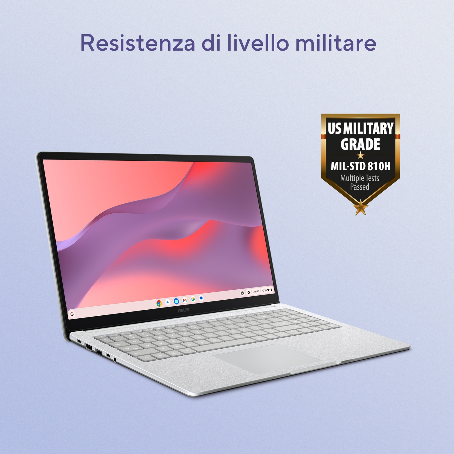 Laptop argentato con certificazione US Military Grade su sfondo viola.