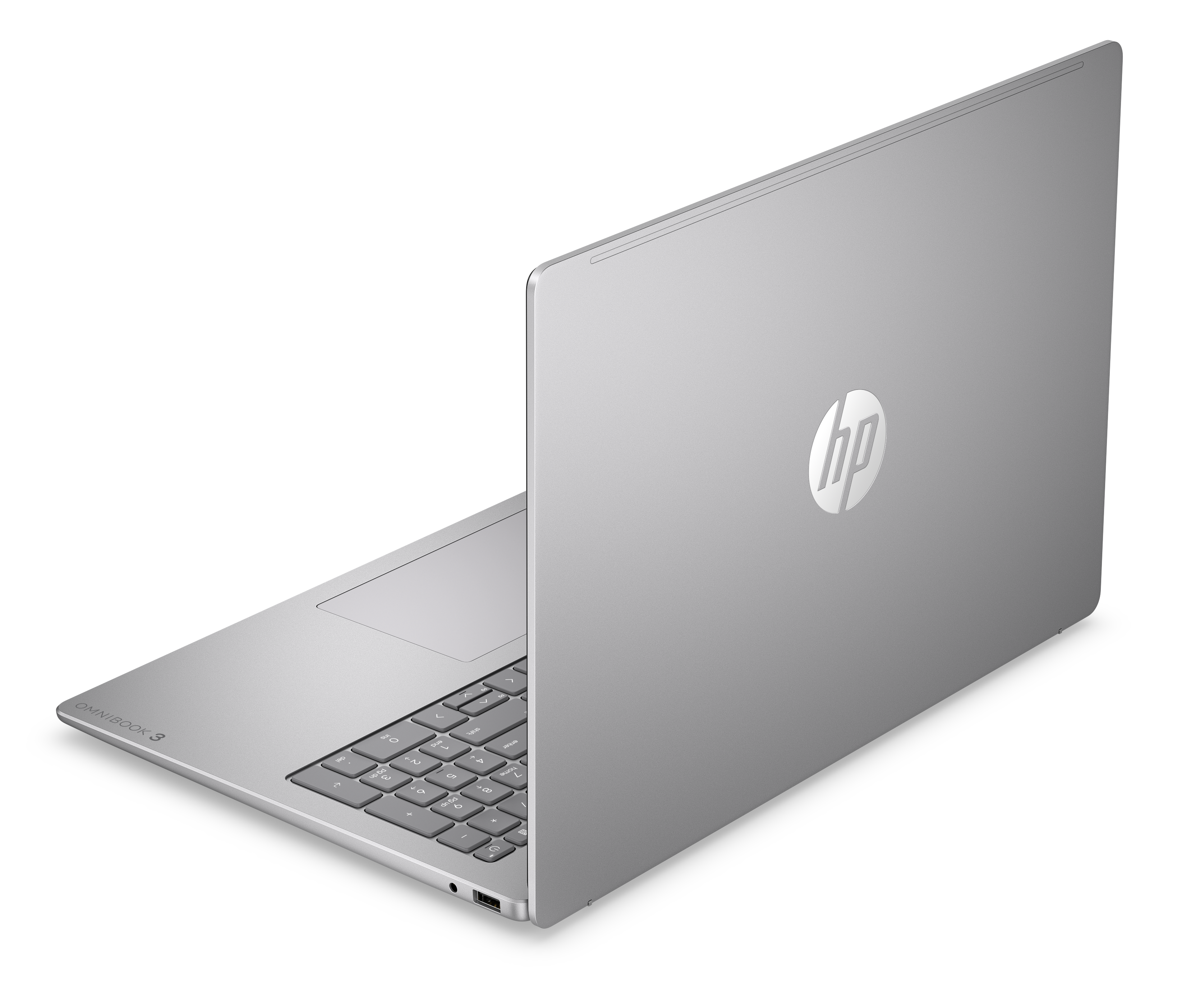 Ein silberner HP Laptop mit beleuchteter Tastatur auf schwarzem Hintergrund.