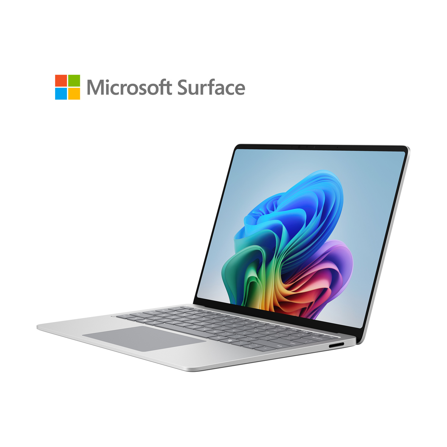 Un laptop argentato con il logo Microsoft Surface e uno sfondo colorato.