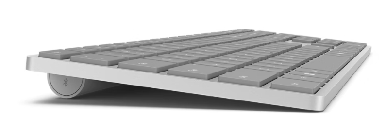 Eine schmale, graue Tastatur mit silbernem Rahmen auf weißem Hintergrund.