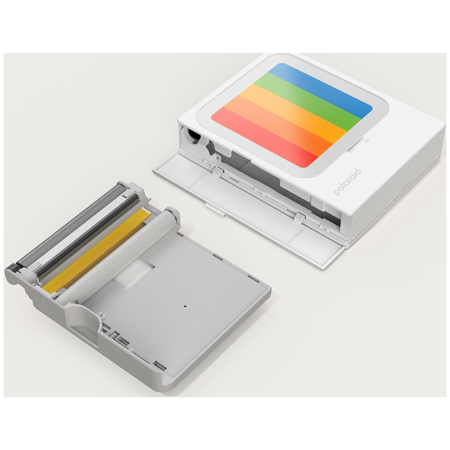 Une imprimante Polaroid blanche avec un compartiment ouvert révélant un rouleau couleur.