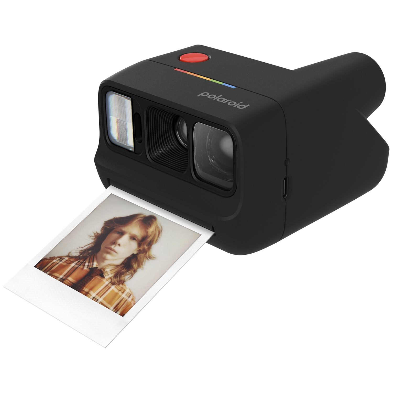 Appareil photo Polaroid noir avec une photo d'un jeune homme en chemise écossaise marron.