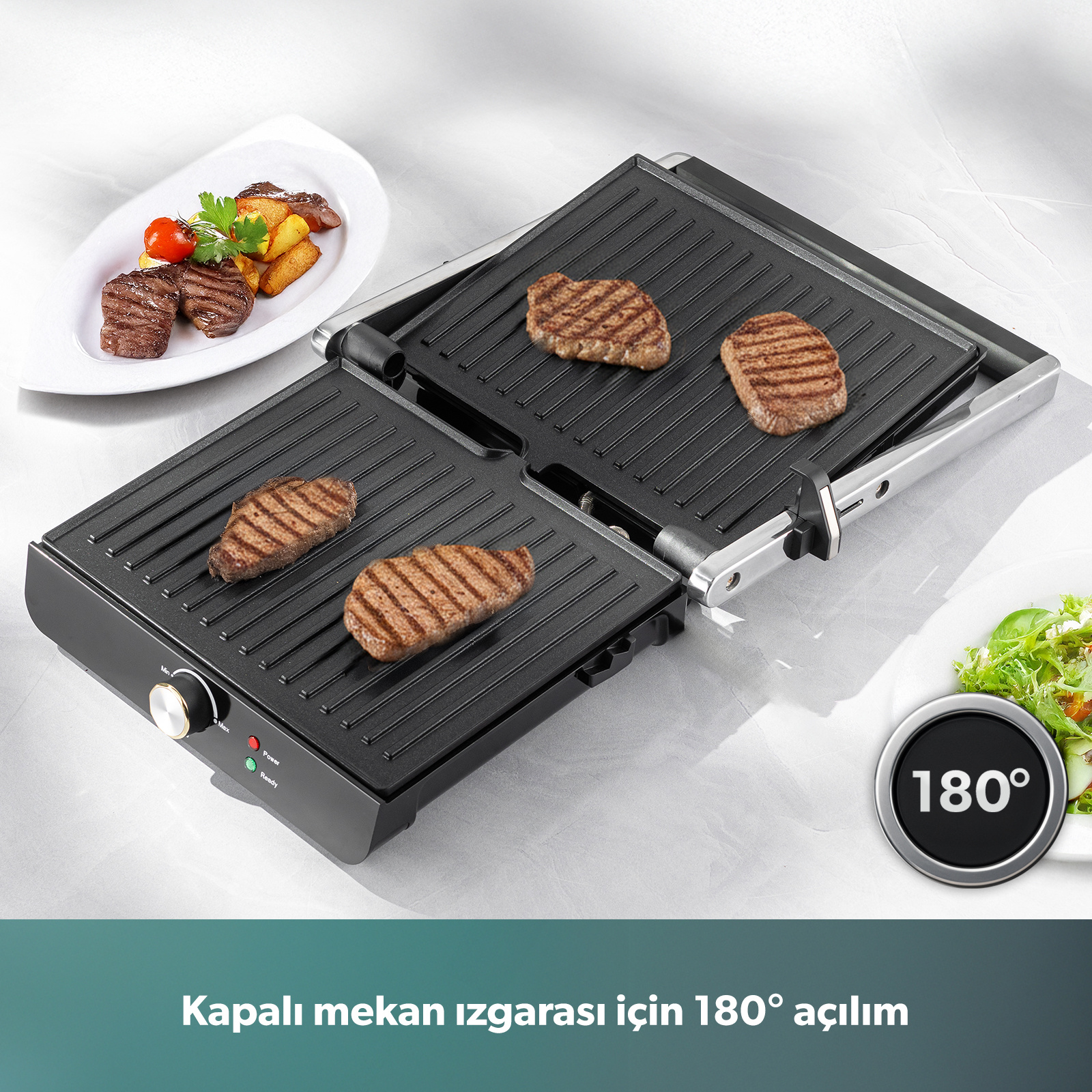 Dört biftek ve garnitürlü açık bir kontaktlı ızgara.