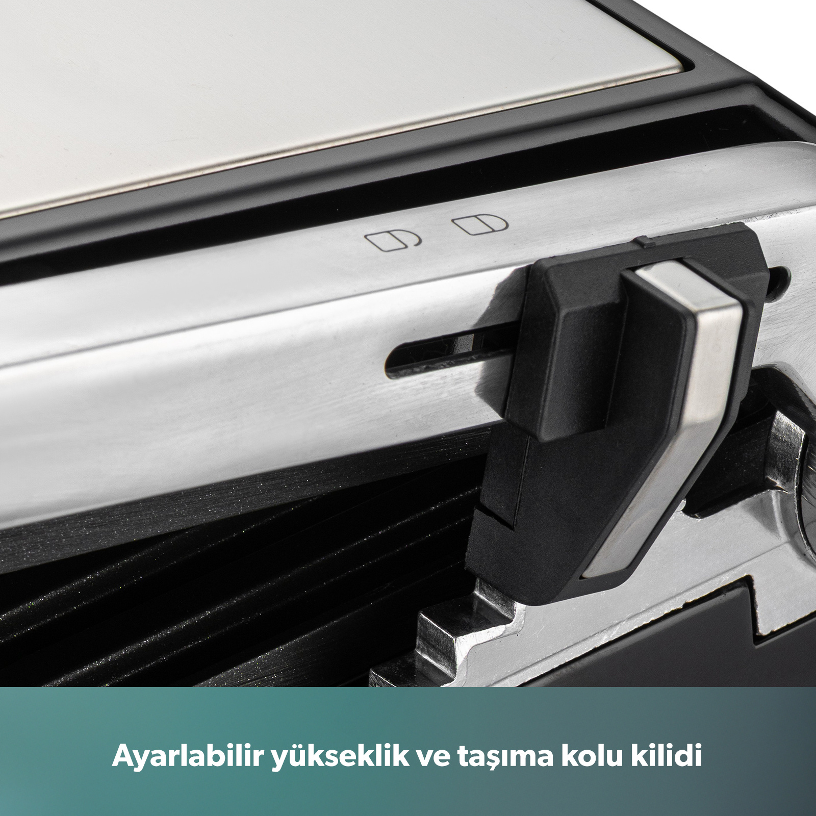 Gümüş rengi cihazın siyah tutamaklı ve kilitleme mekanizmalı yakın çekimi.