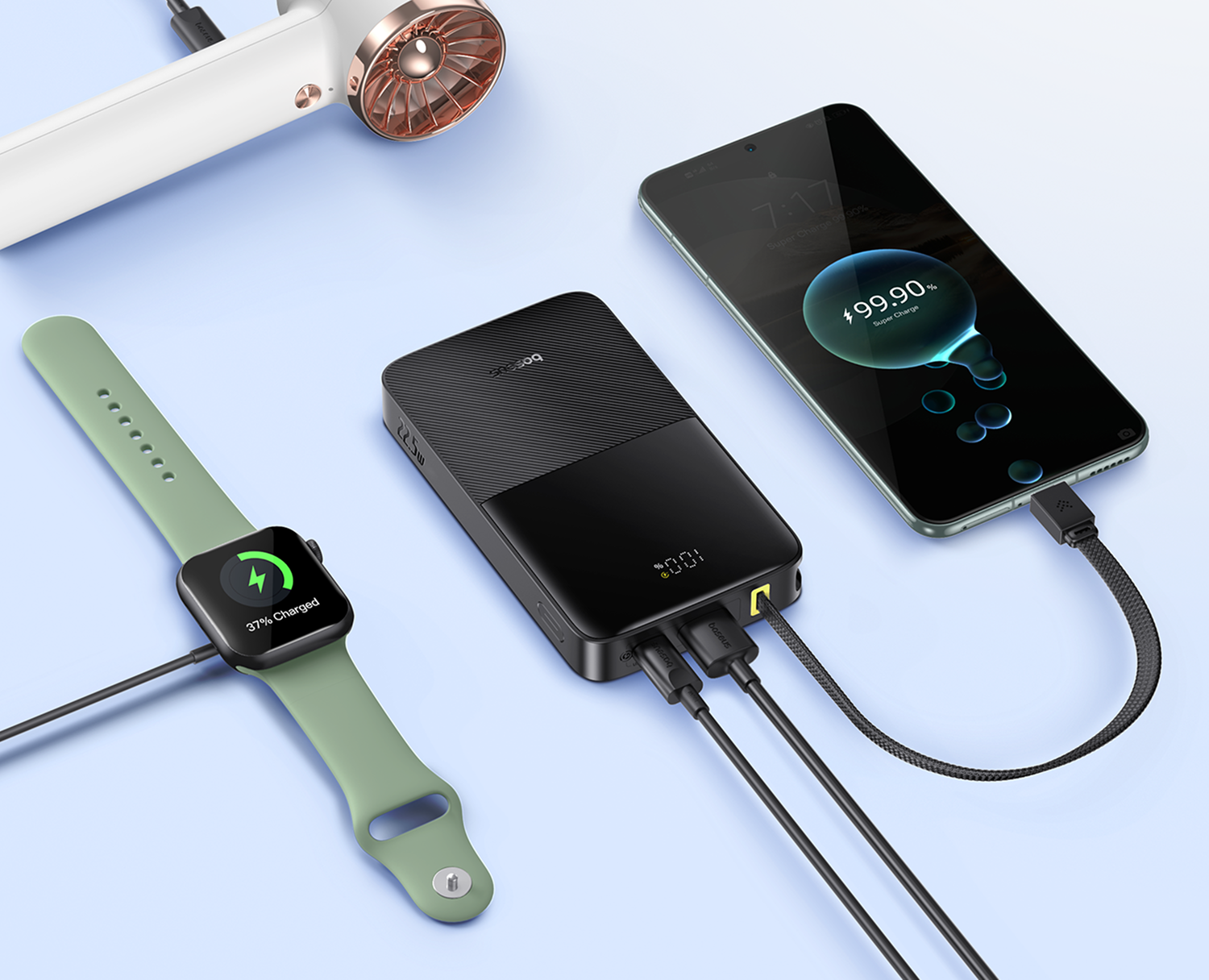 Un banco de energía negro carga un reloj inteligente verde y un teléfono.