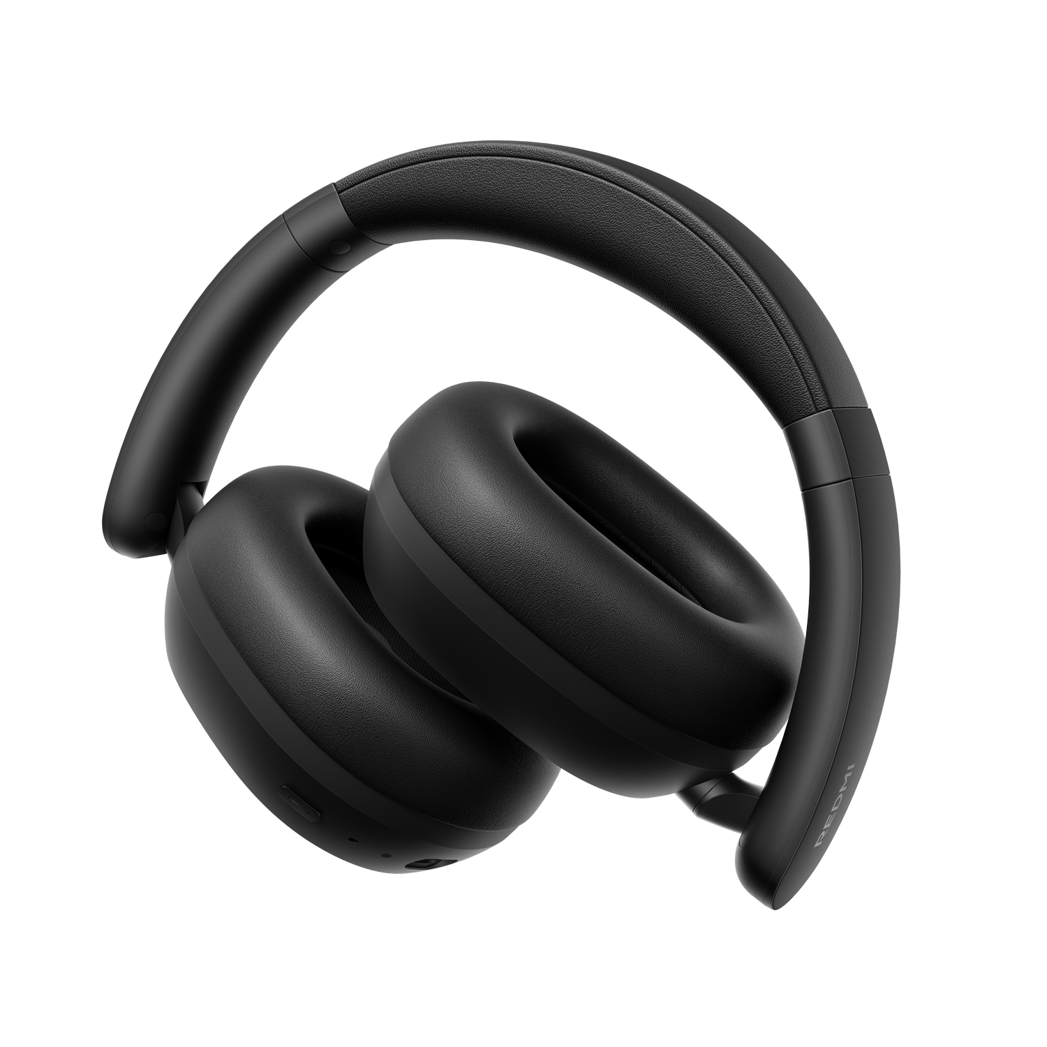 Auriculares negros con almohadillas acolchadas y diadema, sobre fondo gris.