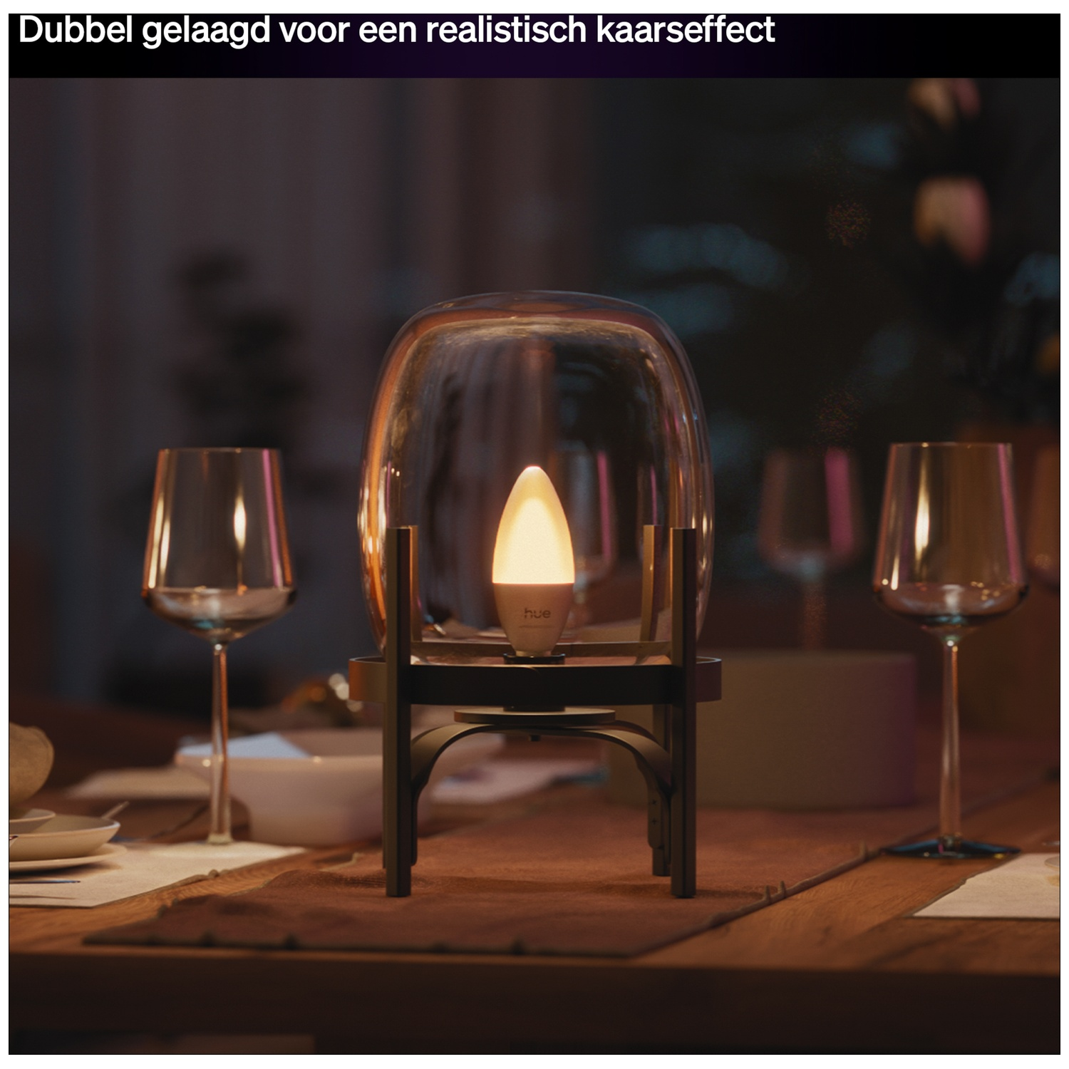 Une lampe suspendue avec un dôme de verre sur une table avec des verres.