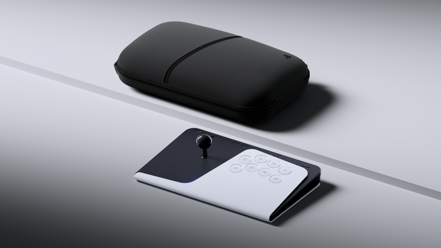 A black case and a white and black controller with joystick and buttons rest on a gray surface.
