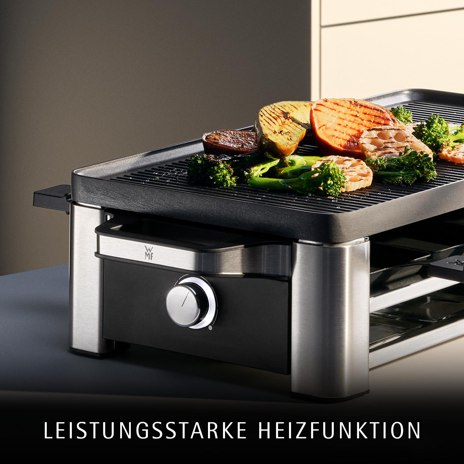 Ein Grill mit gegrilltem Gemüse und Fisch auf der Heizplatte.