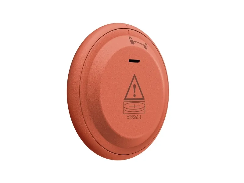 Dispositivo redondo naranja con símbolo de advertencia y número de modelo XT2561-1.