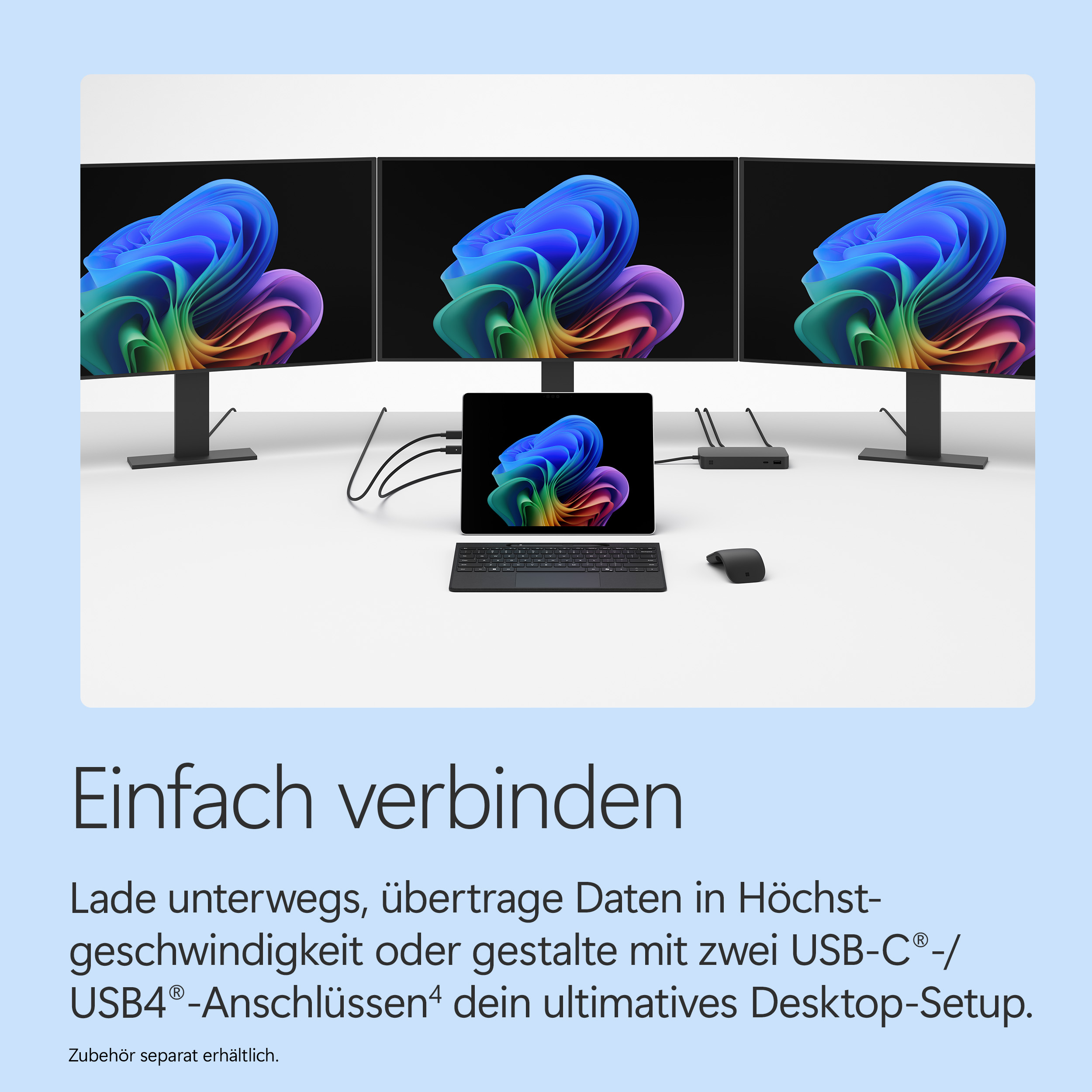 Drei Monitore, ein Tablet, Tastatur, Maus und Dockingstation auf einem Tisch.