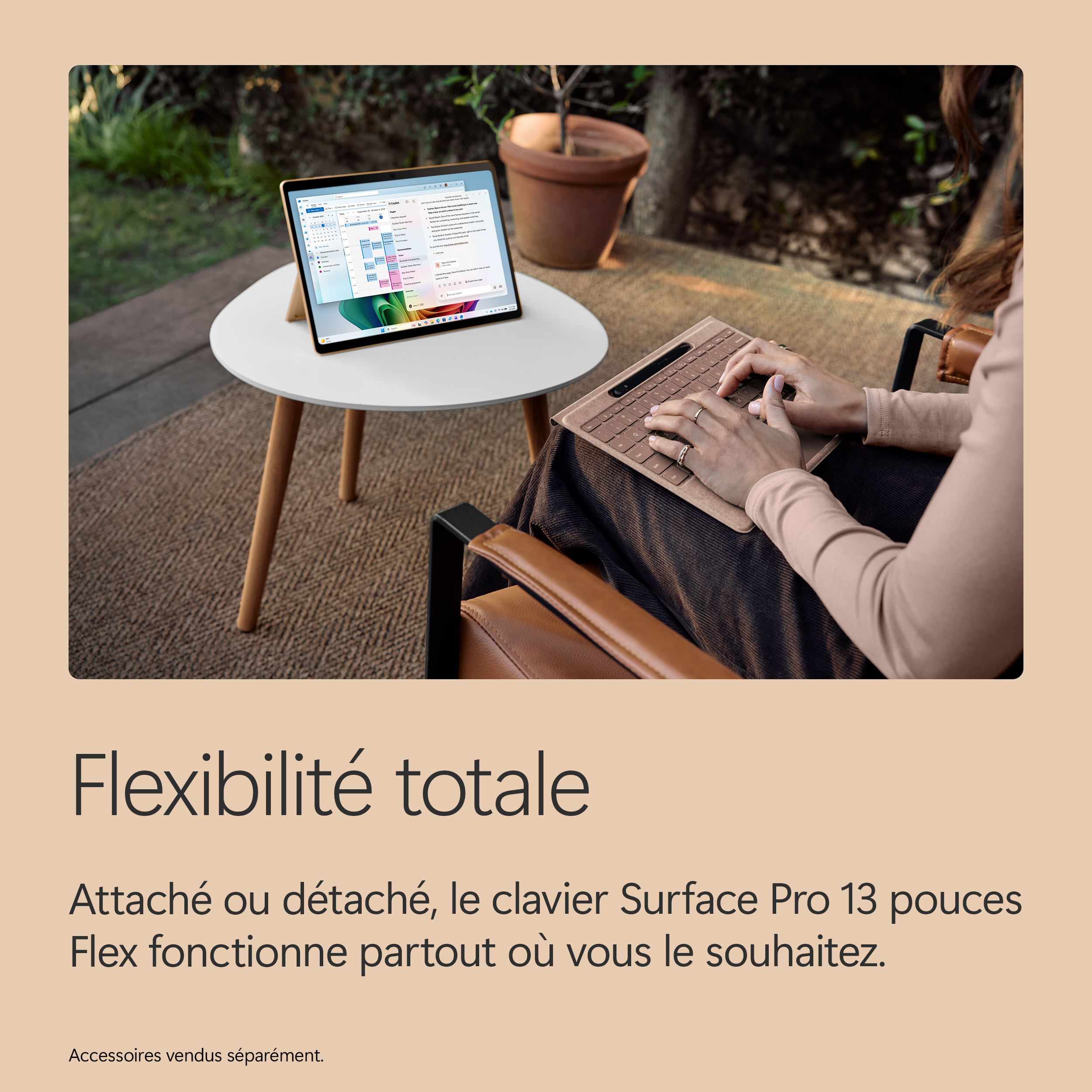 Femme tapant sur un clavier à côté d'un ordinateur portable en extérieur.