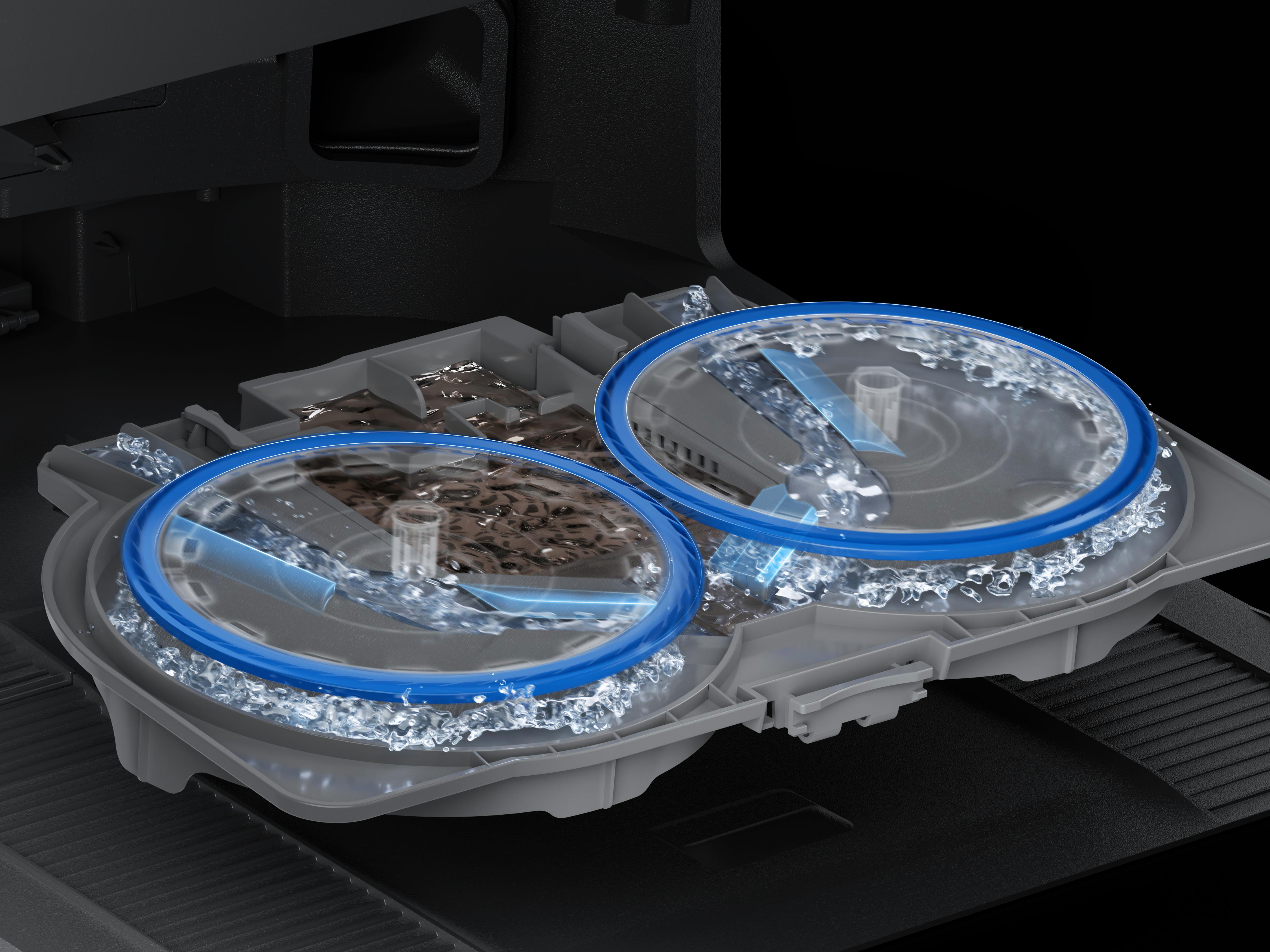 Zwei rotierende Sprühdüsen mit blauem Rand spritzen Wasser in einer Spülmaschine.