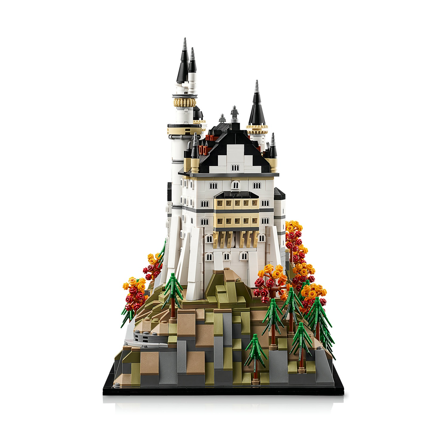 Un modello Lego di un castello su una roccia con alberi e fogliame colorato.