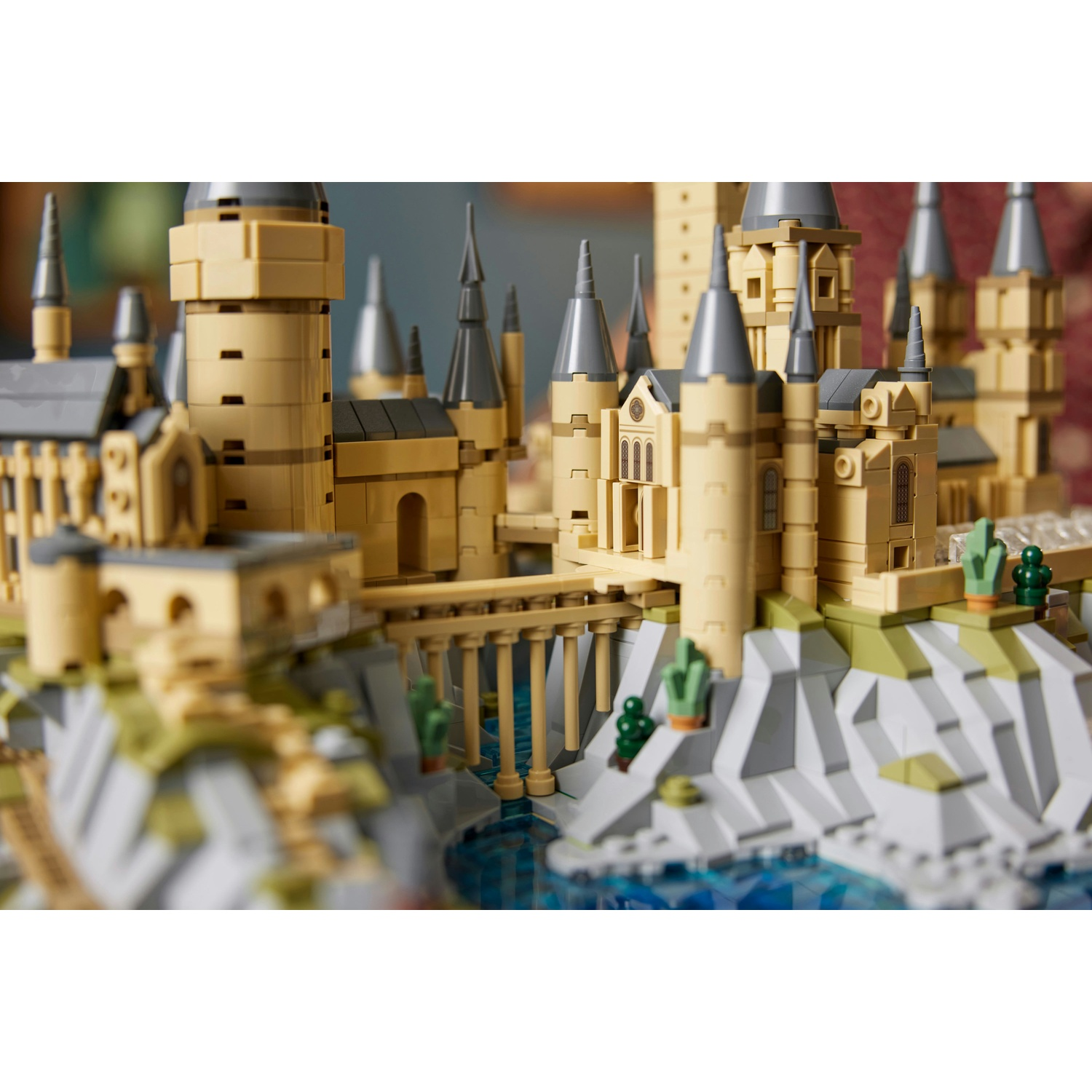 Un modello Lego di un castello medievale con torri e ponti sull'acqua blu.