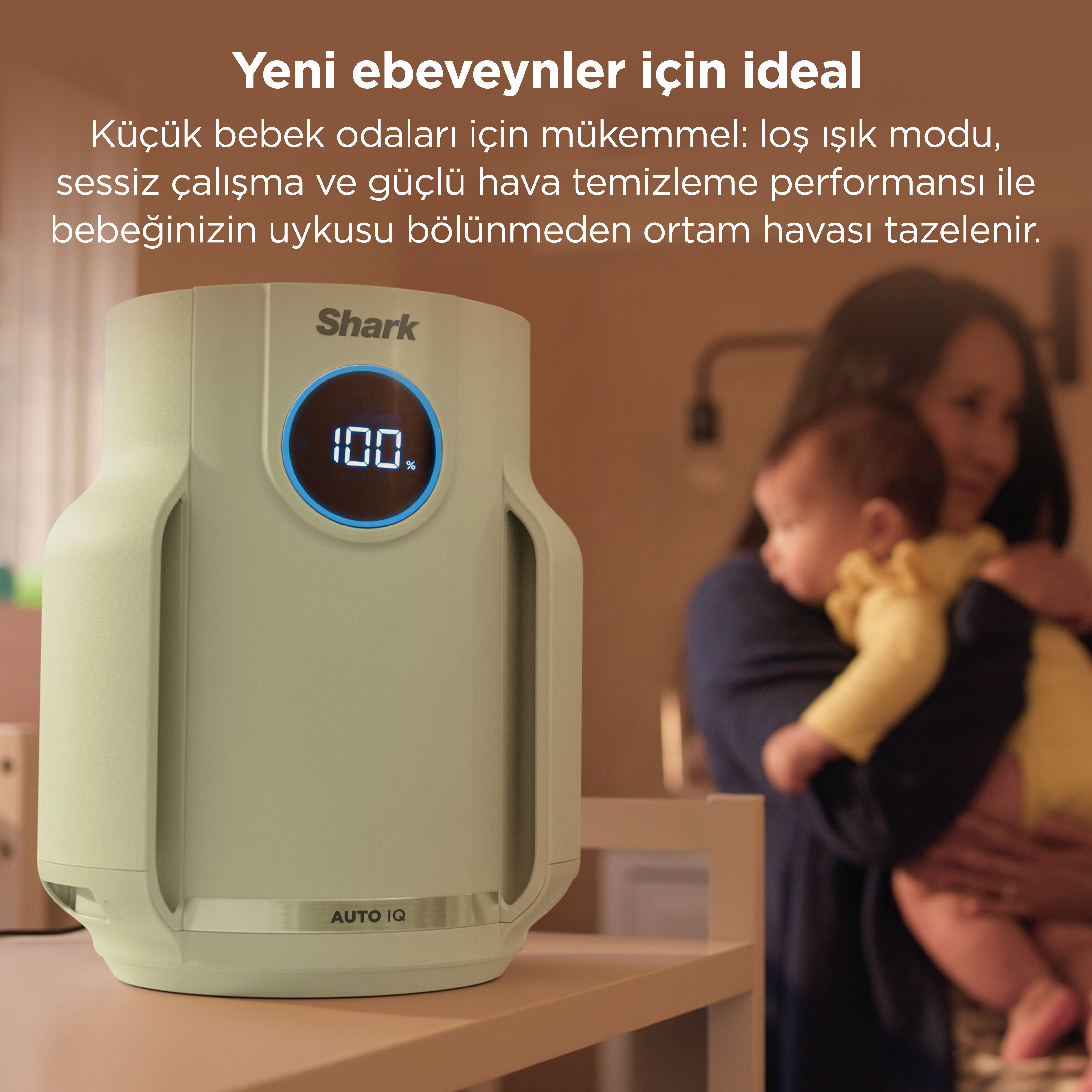 Açık yeşil bir hava temizleyici, bir bebek tutan bir kadının yanında gösterilmektedir.