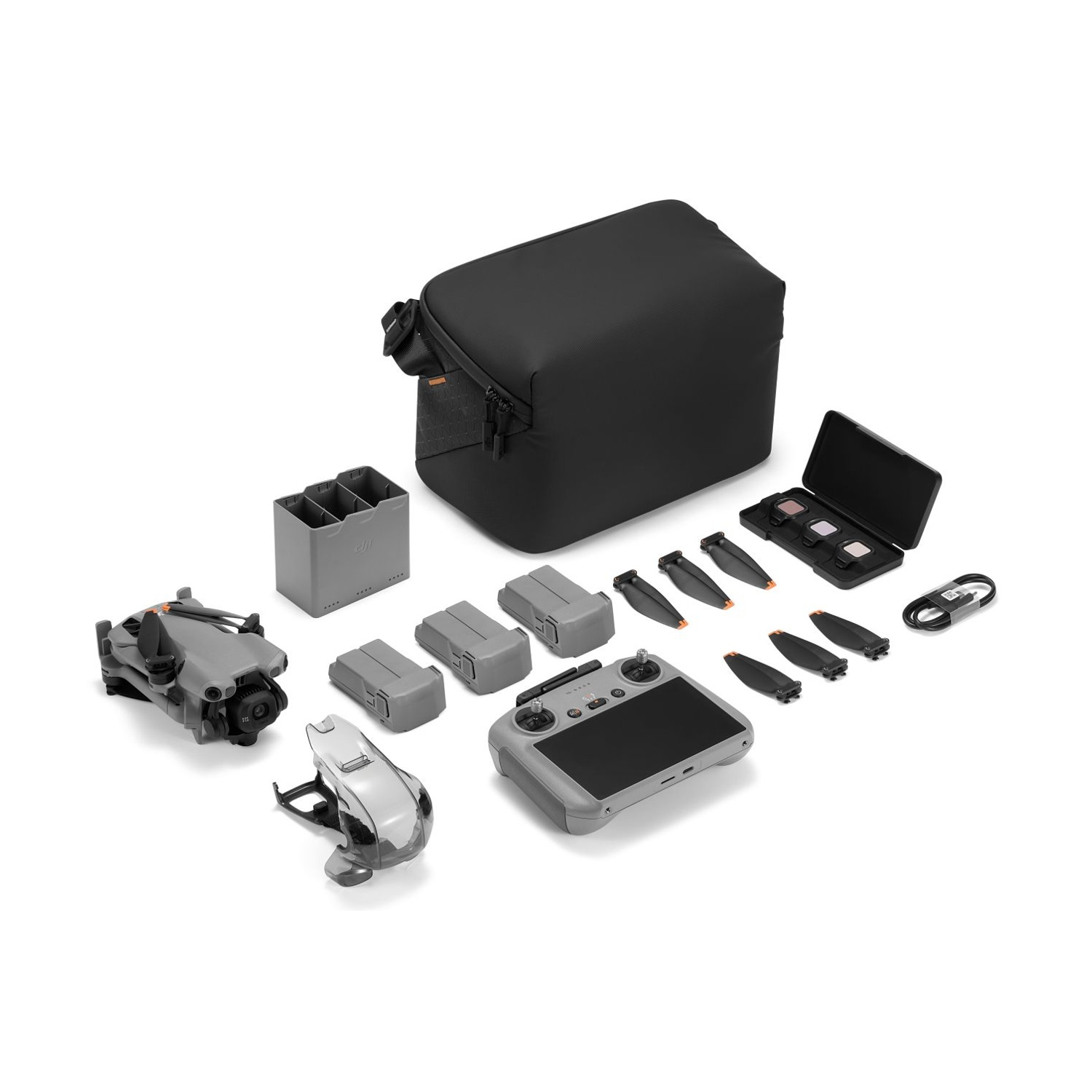 Kit drone DJI grigio con telecomando, batterie, eliche e borsa.