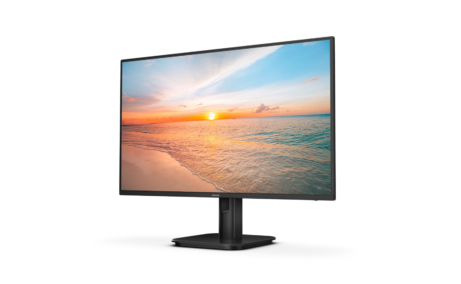 Un monitor negro muestra un atardecer en la playa con olas y nubes.
