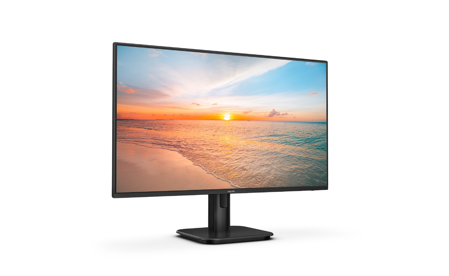 Un monitor de computadora muestra una puesta de sol sobre el océano y una playa de arena.