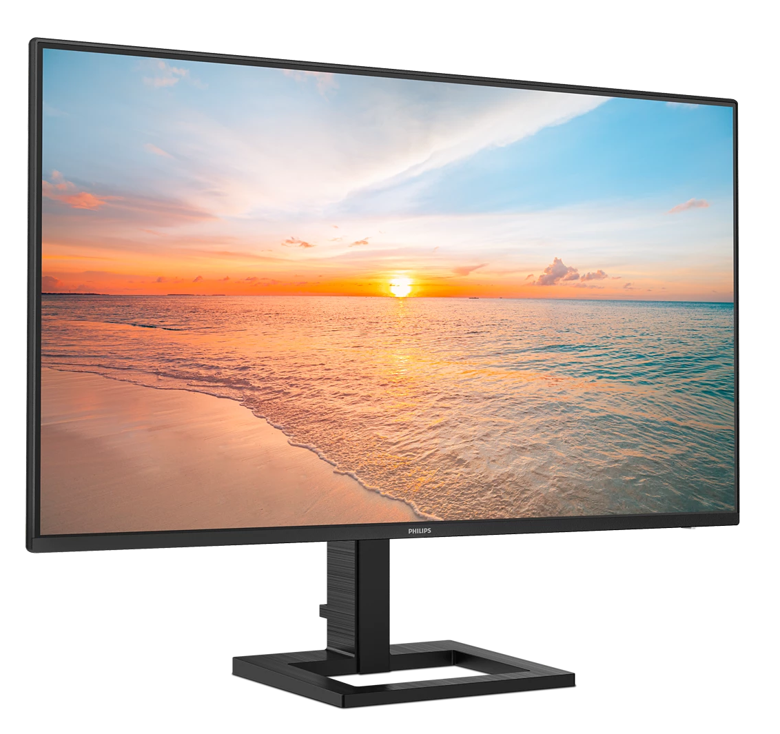 Un monitor muestra un atardecer en la playa con olas y nubes.