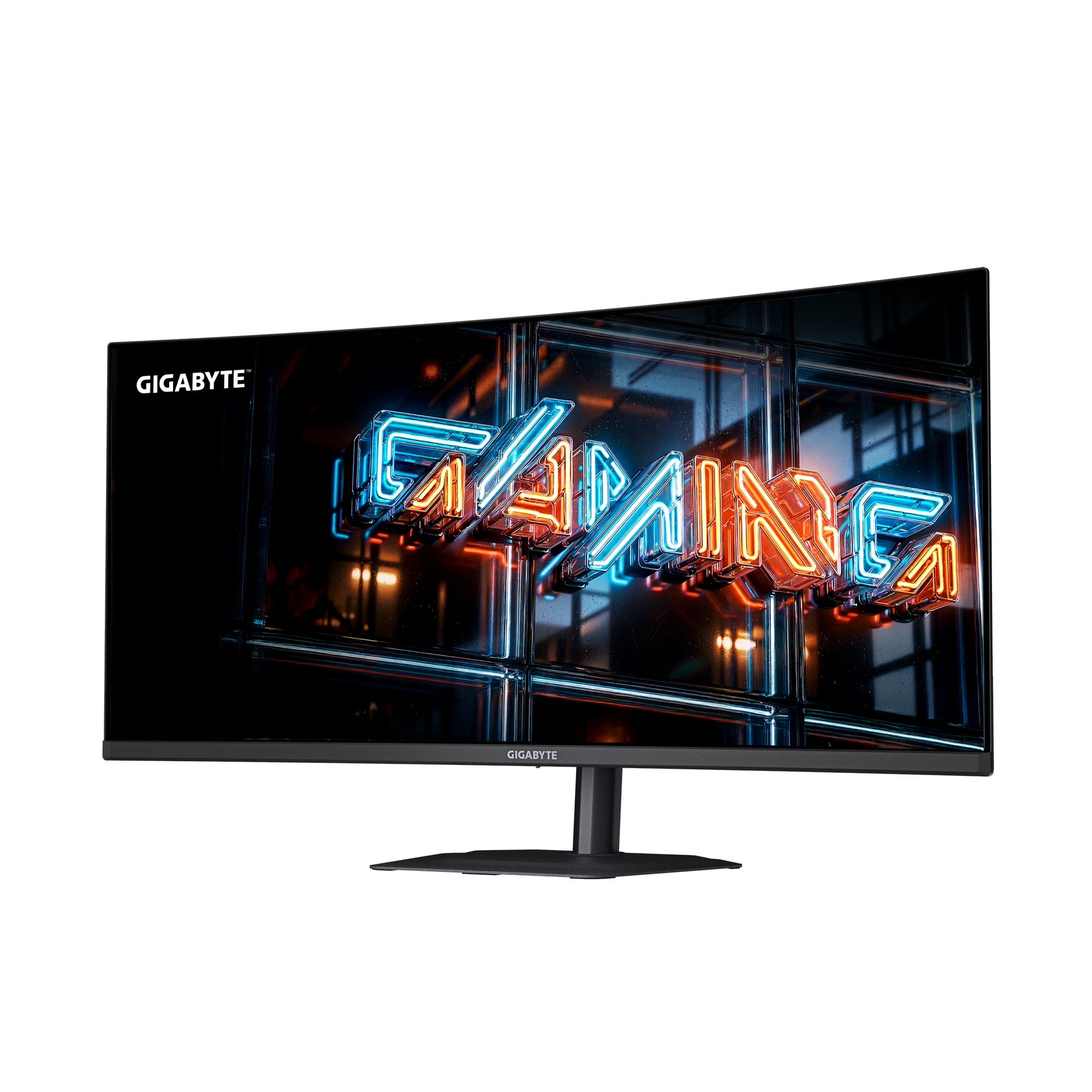 Un monitor GIGABYTE muestra texto de neón "GAMING" en azul y naranja sobre fondo oscuro.