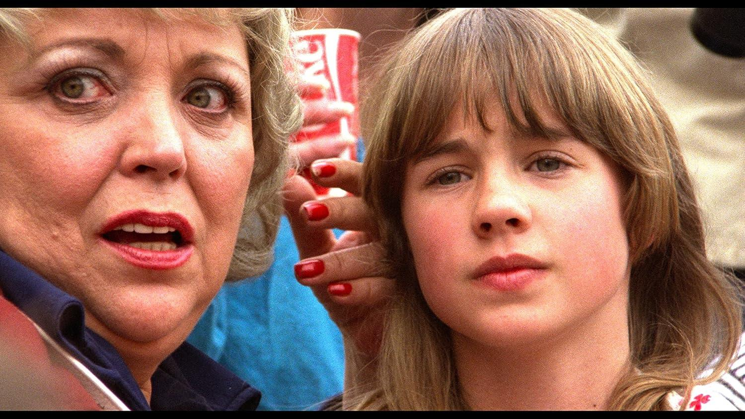 Eine Frau mit roten Lippen und ein junges Mädchen mit braunen Haaren.
