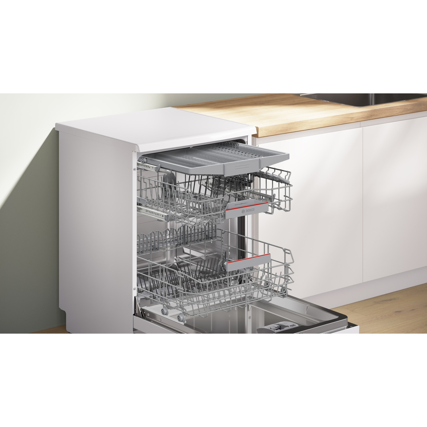 Open white dishwasher with pull-out baskets, silver racks, and cutlery drawer.