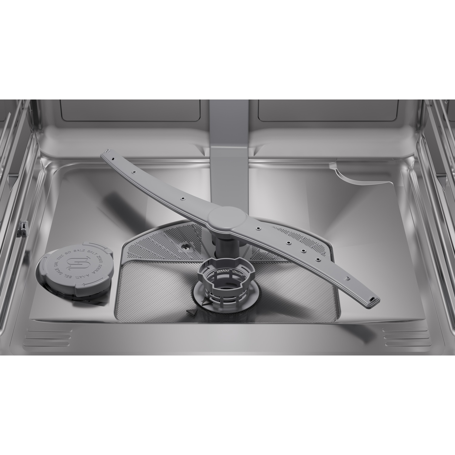 Interior of a dishwasher with spray arm and salt compartment.