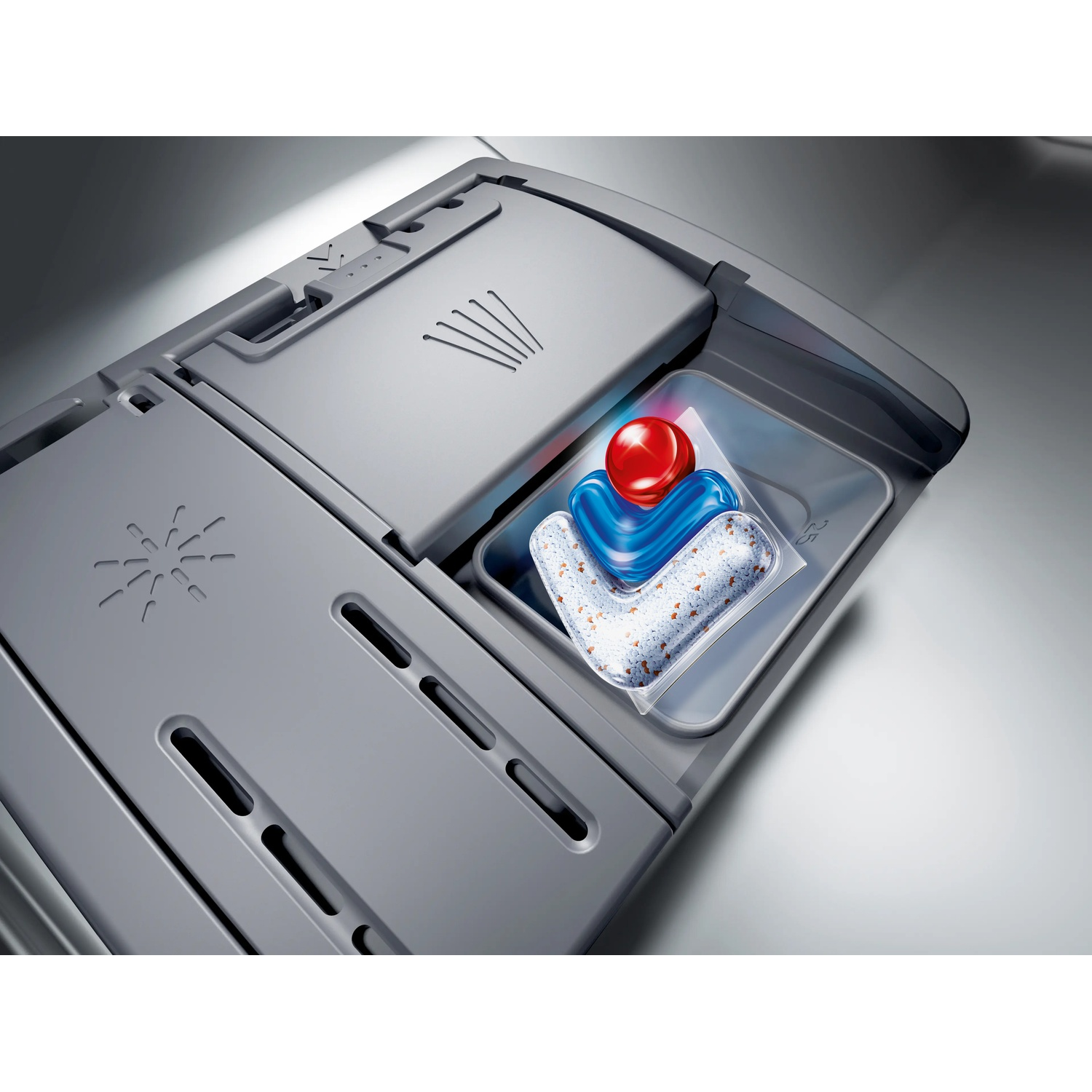 Dishwasher tablets in a compartment with red and blue gel and granules.
