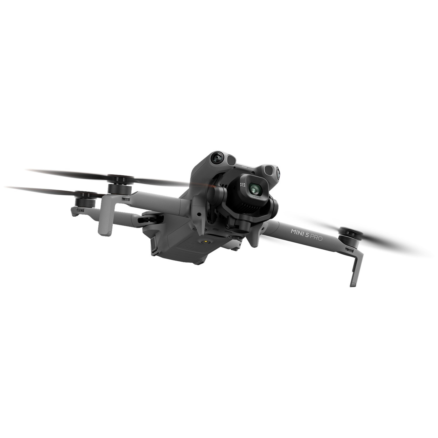 Gray mini drone with camera in flight, propellers spinning.