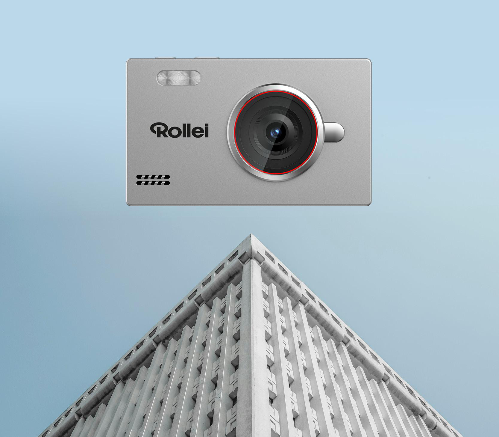 Silberne Kamera mit Rollei-Logo über einem modernen Gebäude aus Beton.