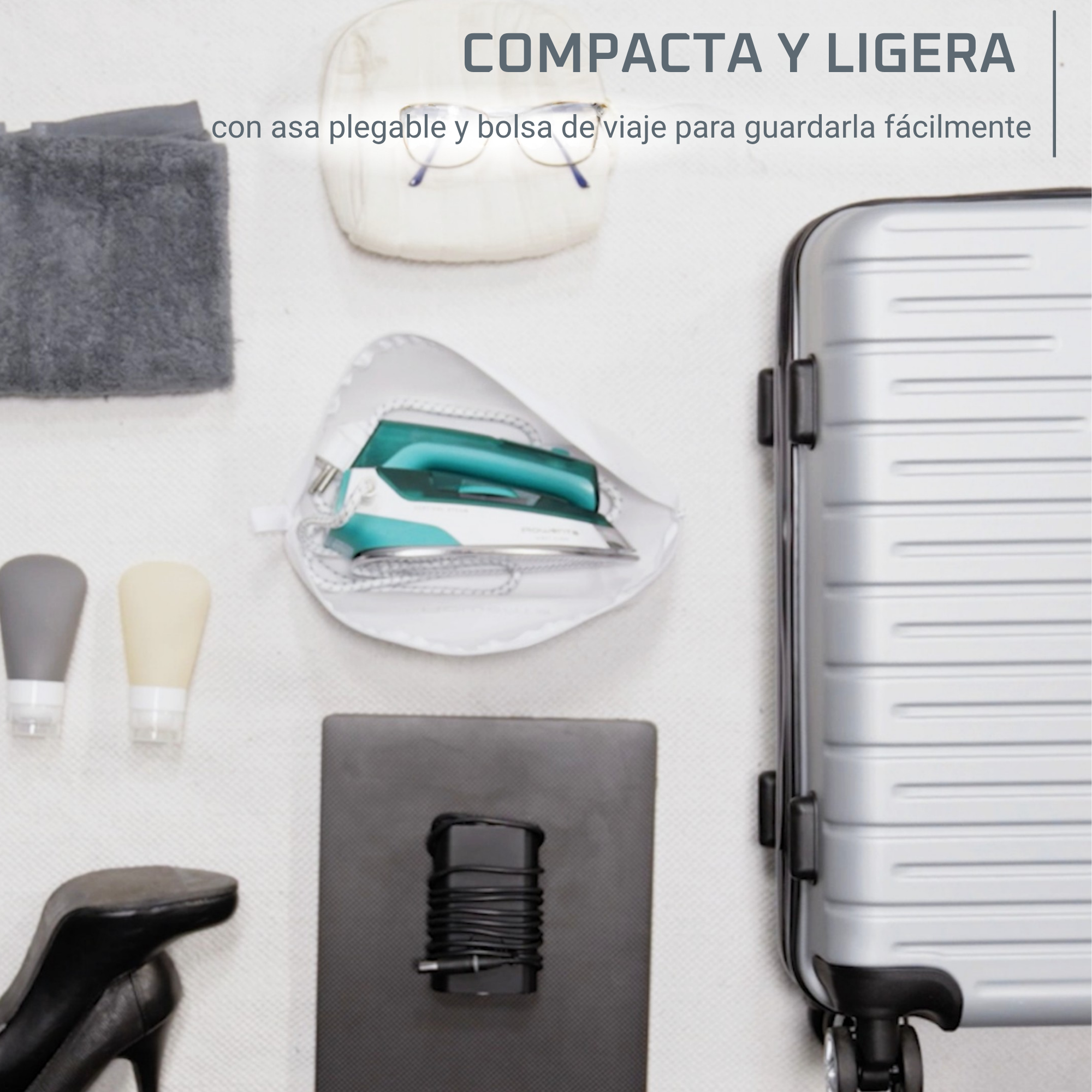 Una plancha en una bolsa, junto a una maleta y artículos de tocador.