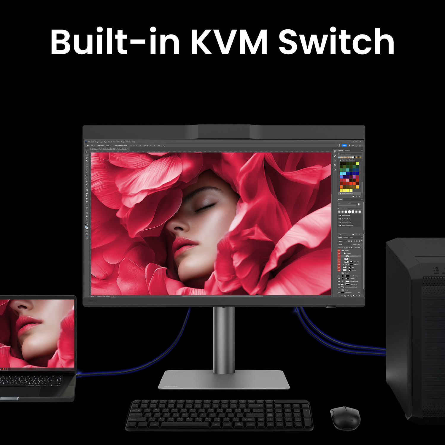 Un grande monitor mostra un volto circondato da fiori rossi. Un laptop e un PC sono collegati.