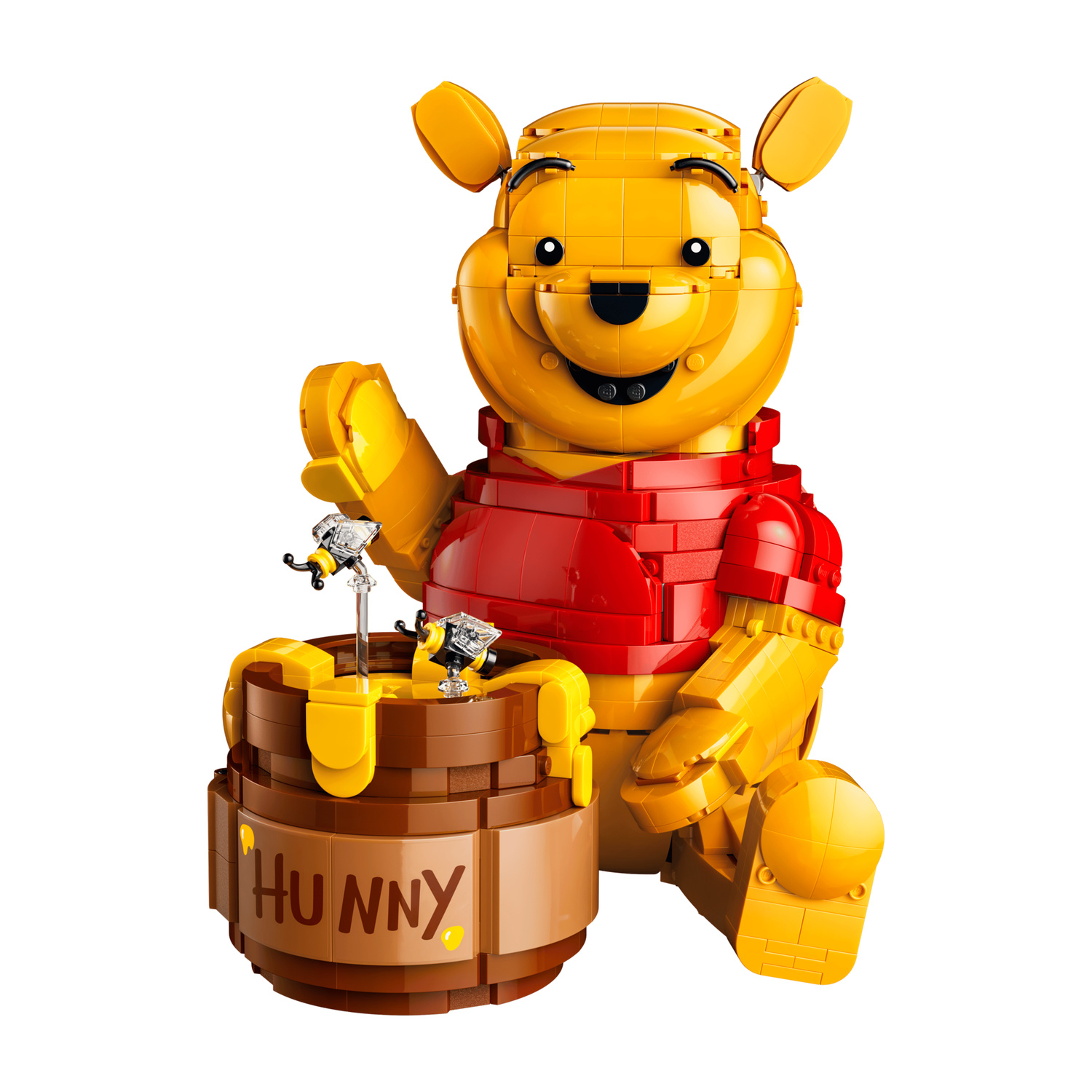 Un Winnie the Pooh Lego giallo siede accanto a un vaso di miele.